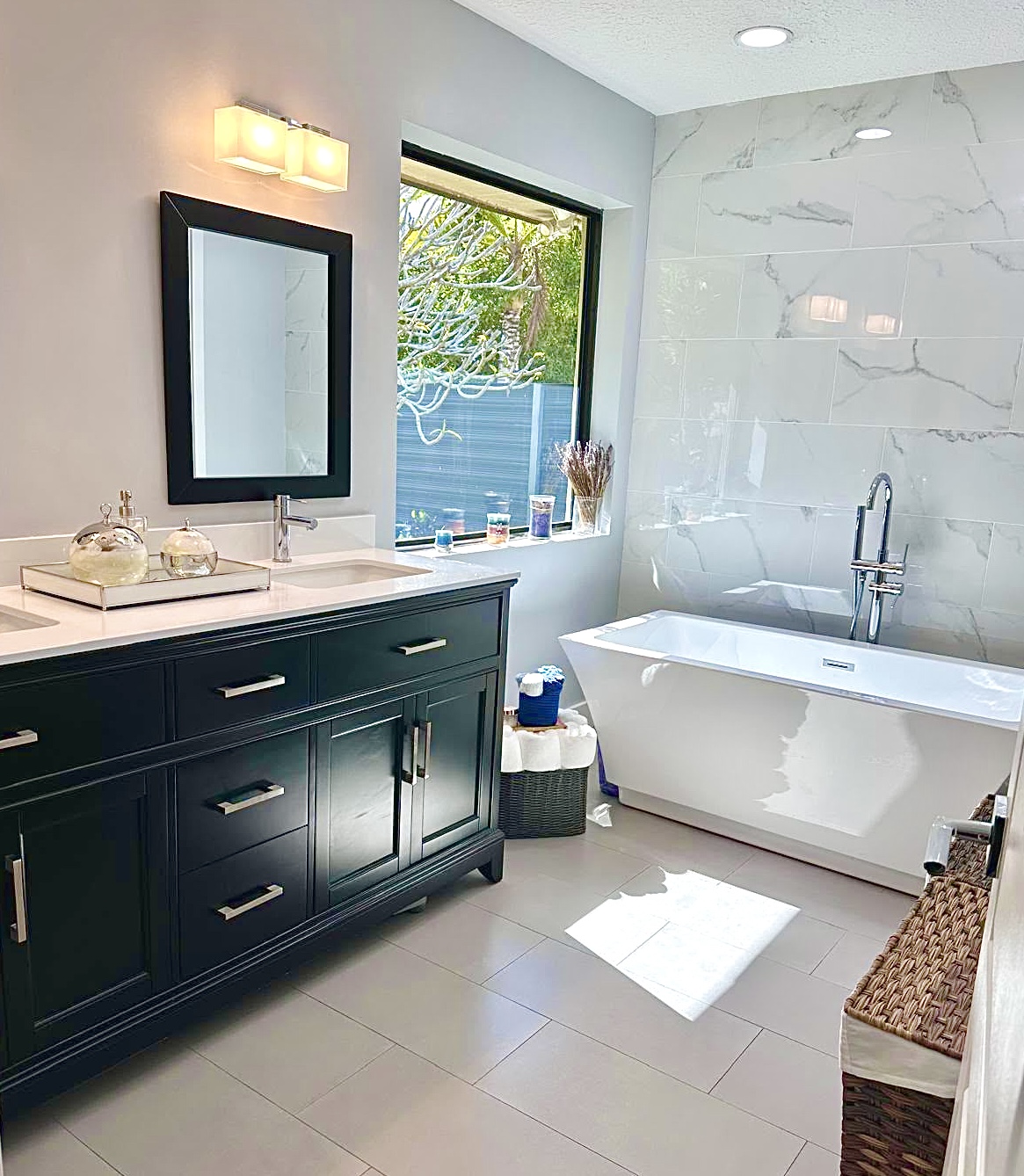 A spotless marble bathroom with a freestanding soaking tub after a Sparkle deep clean